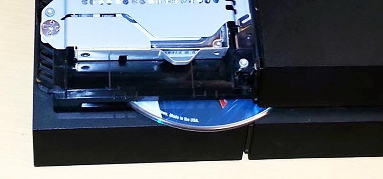 Press and hold the release button while gently pulling the disc drive out slightly.
Power on the console while still holding the release button.